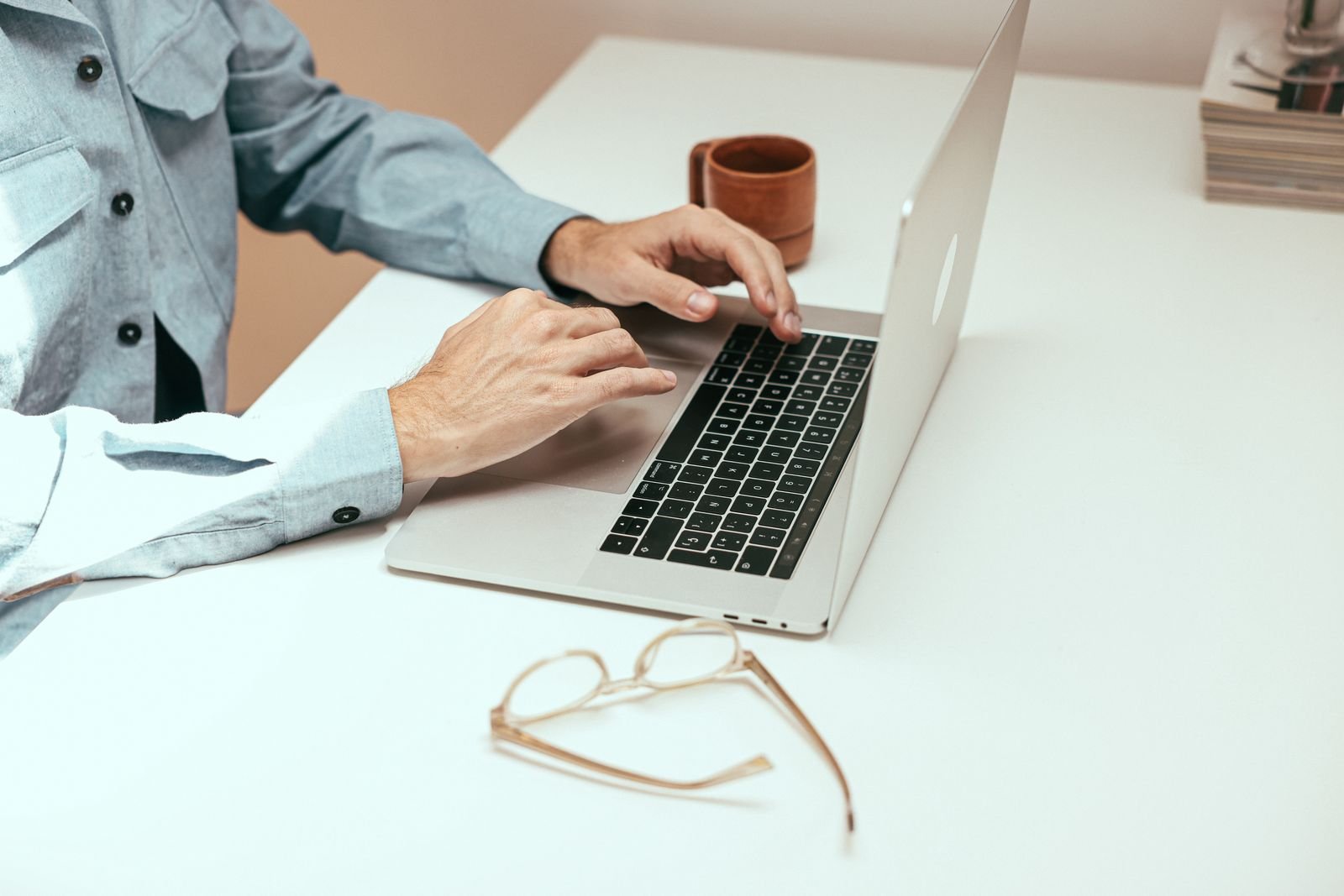Working at a desk with glasses and a coffee nearby