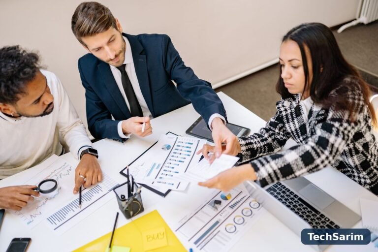 Business professionals collaborating in a meeting with charts and documents on the table