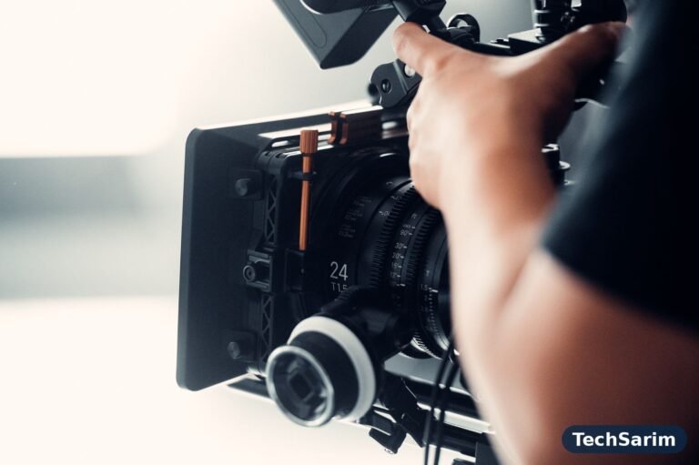 A camera operator filming with a professional video camera on a studio set