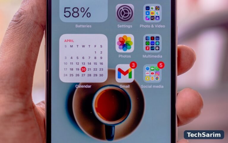 A hand holding an iPhone whose battery widget shows 58 percent charge