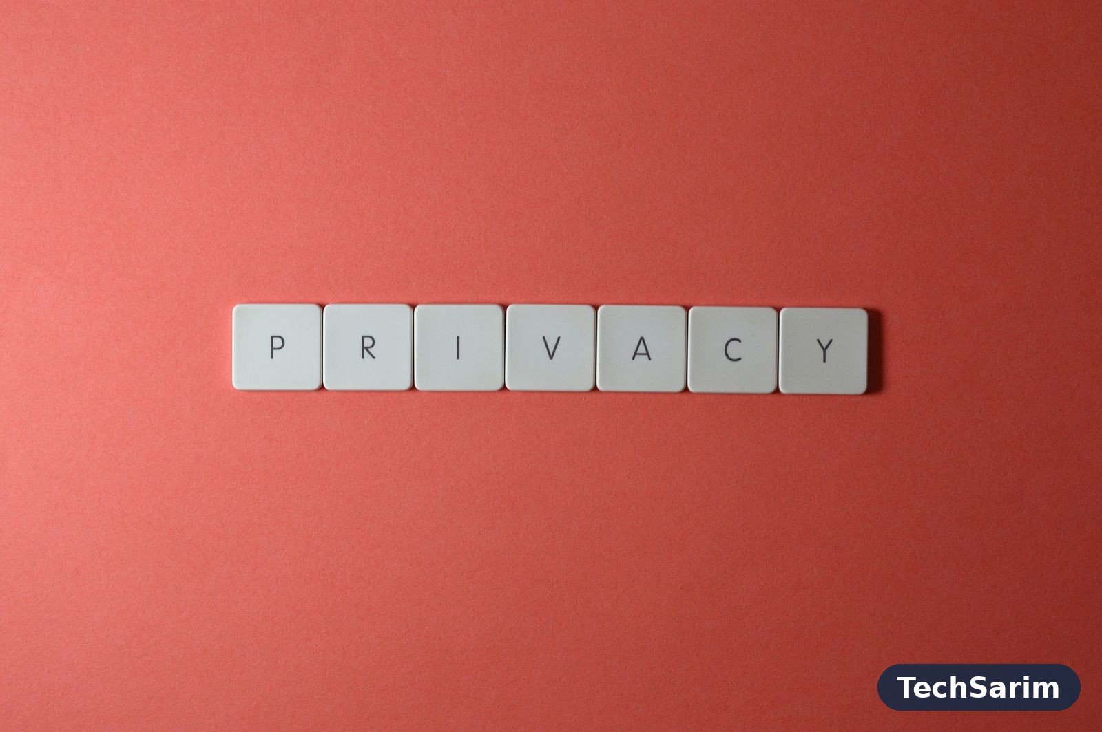 White letter tiles spelling PRIVACY in a row on a plain red background