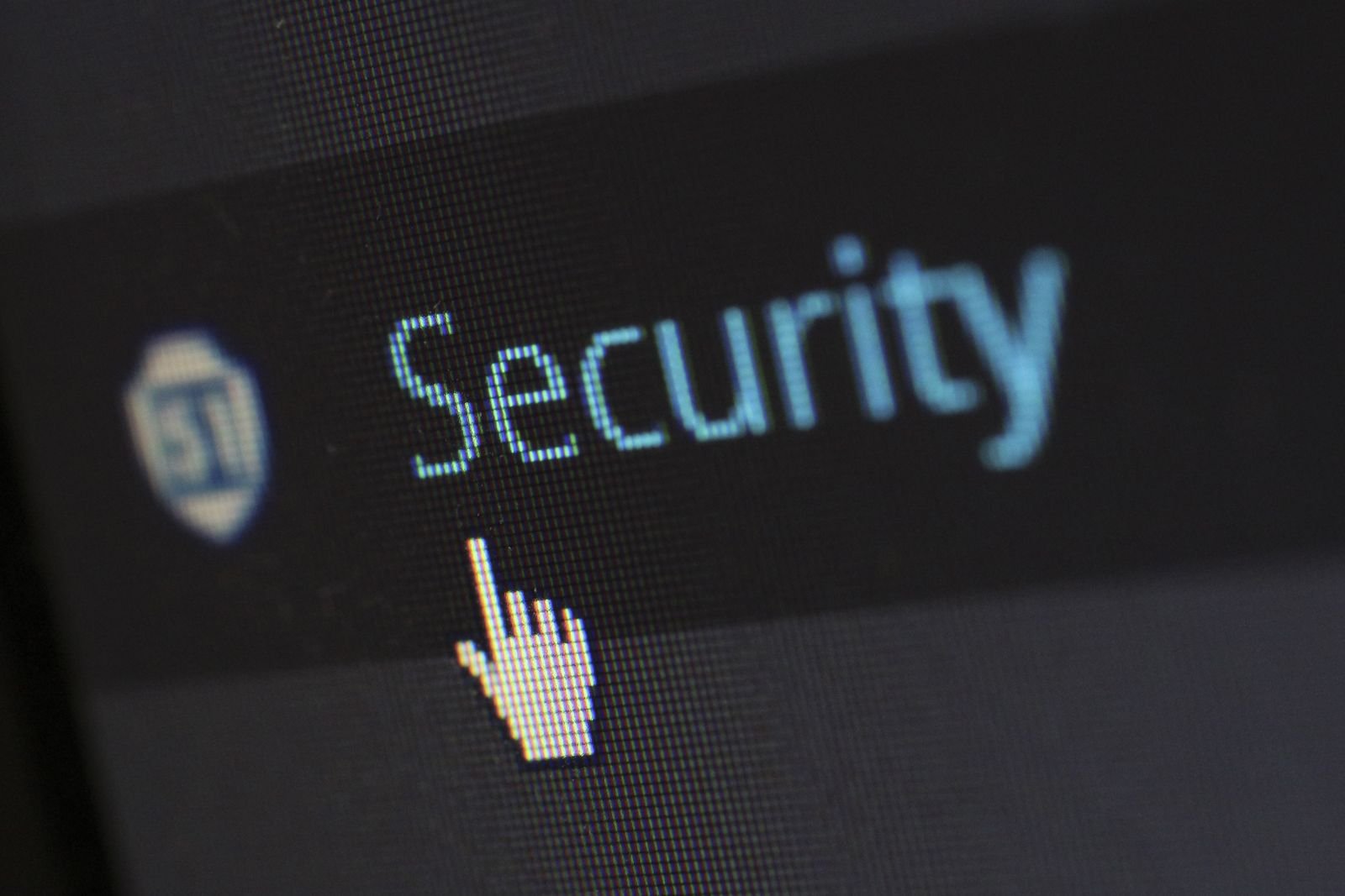 Close-up of a computer screen showing the word Security beside a shield icon, with a mouse pointer hovering below it